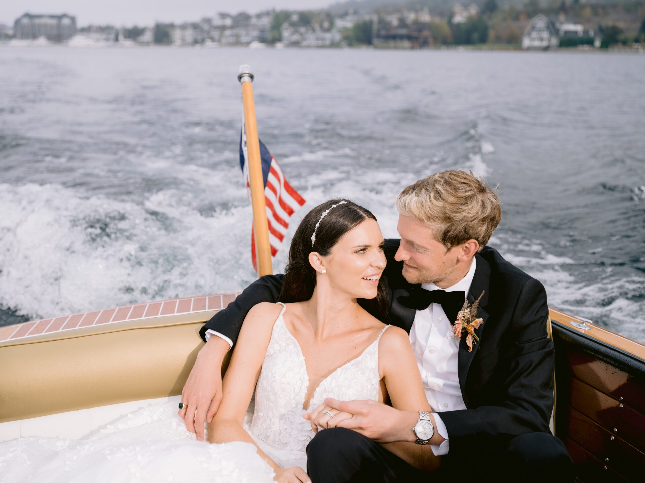A bride and groom get cozy on a Lake Michigan boat ride