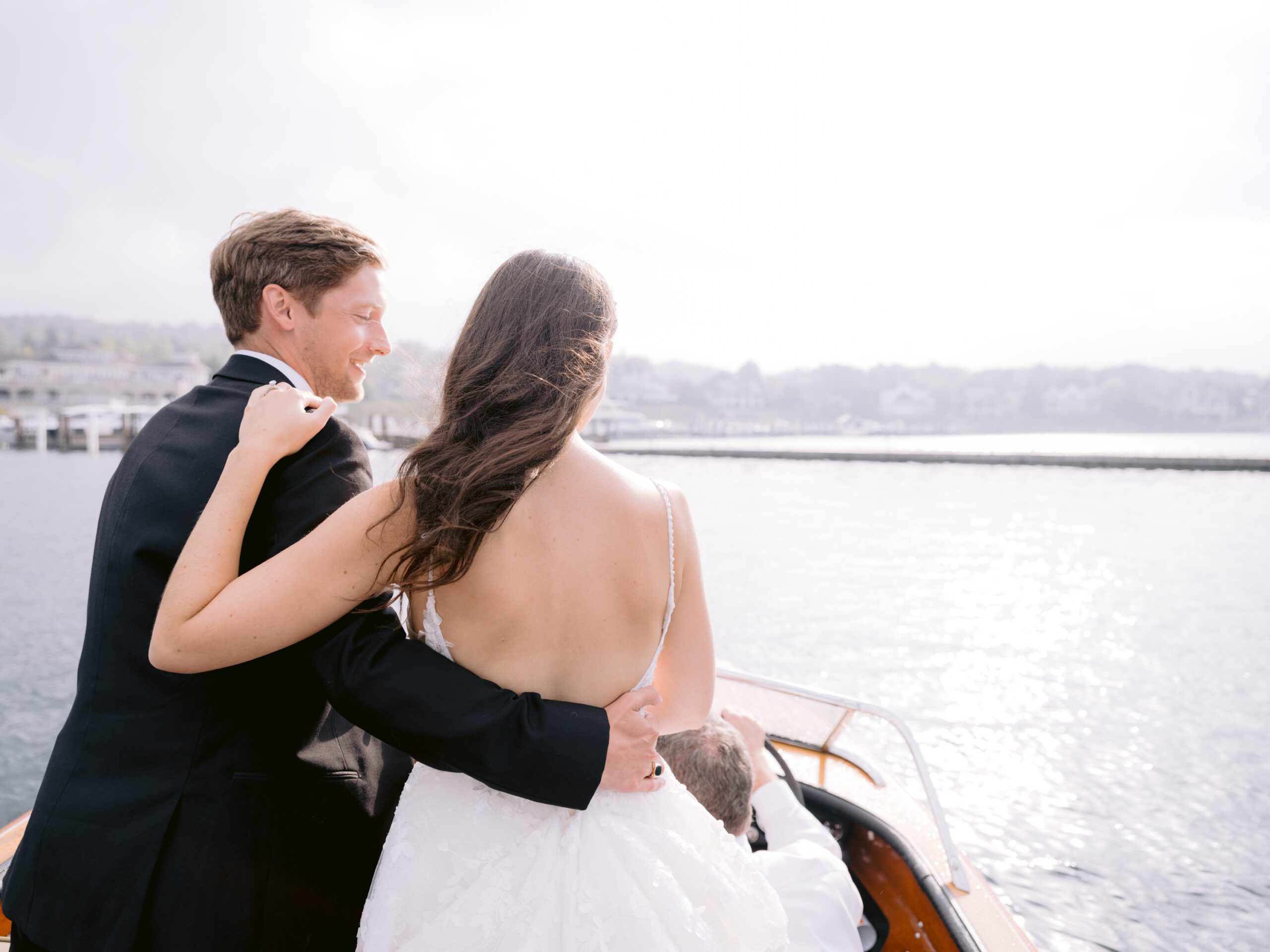A bride and groom enjoy the sunshine on Lake Michigan boat ride
