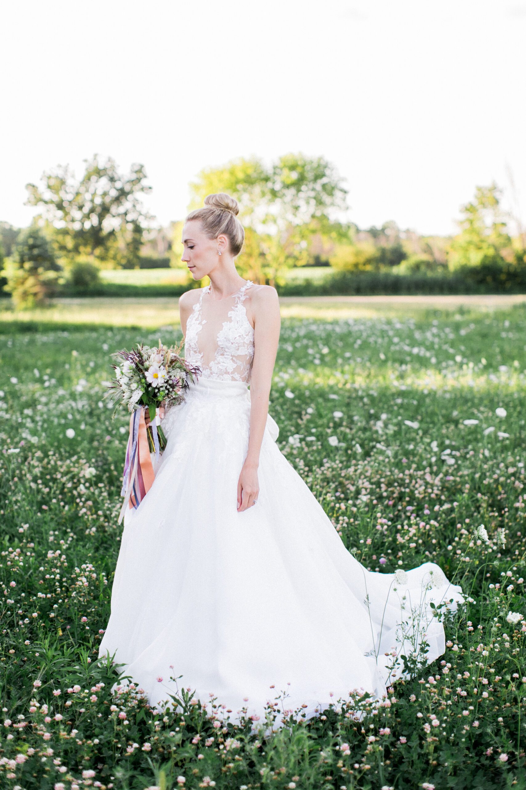 A bride walks through a field of wildflowers