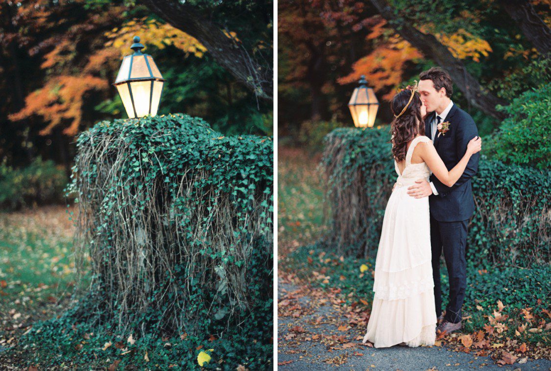 A couple kiss beside a fairytale like ivy fence