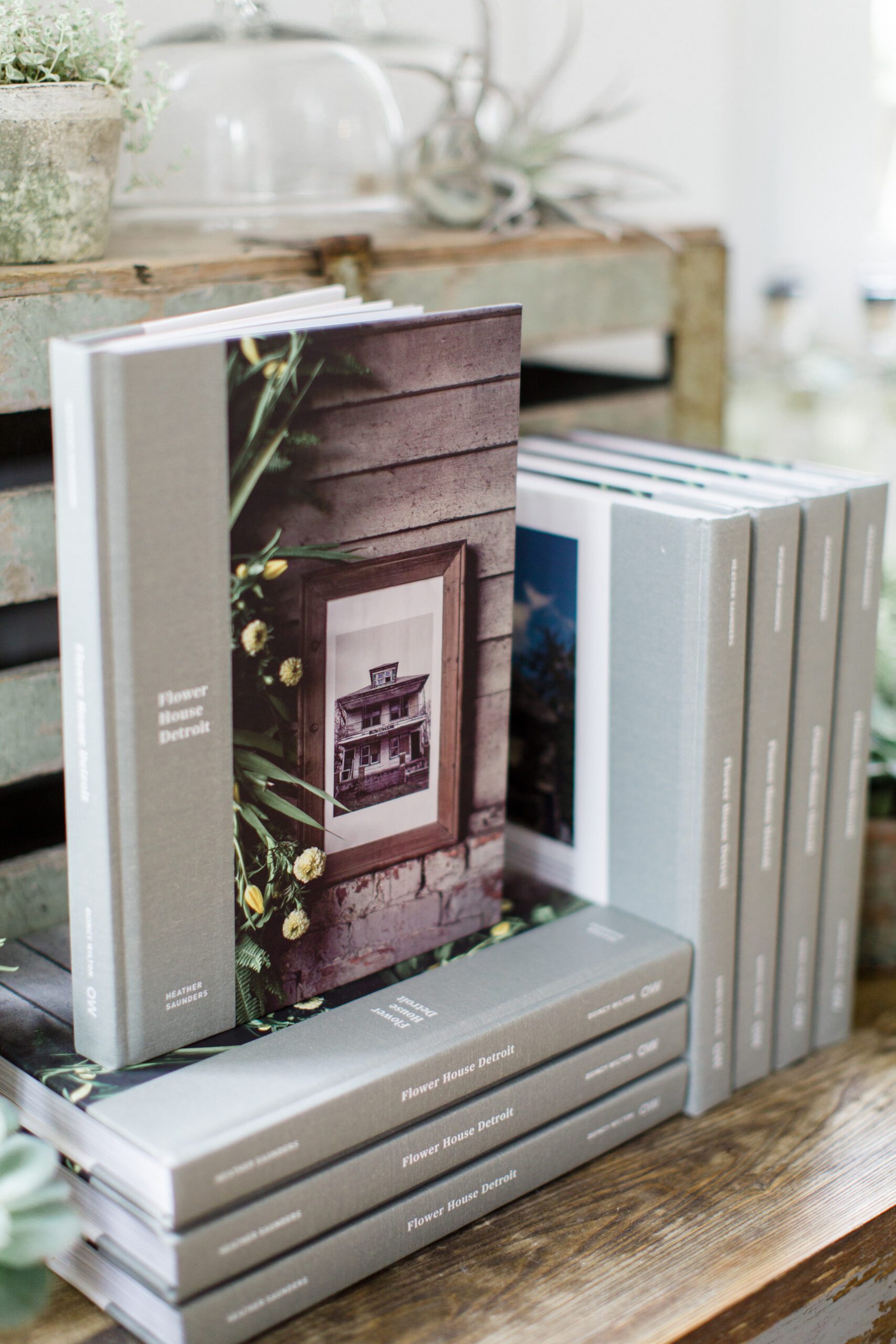 A photograph of a stack of Flower House Detroit book highlighting brand photography