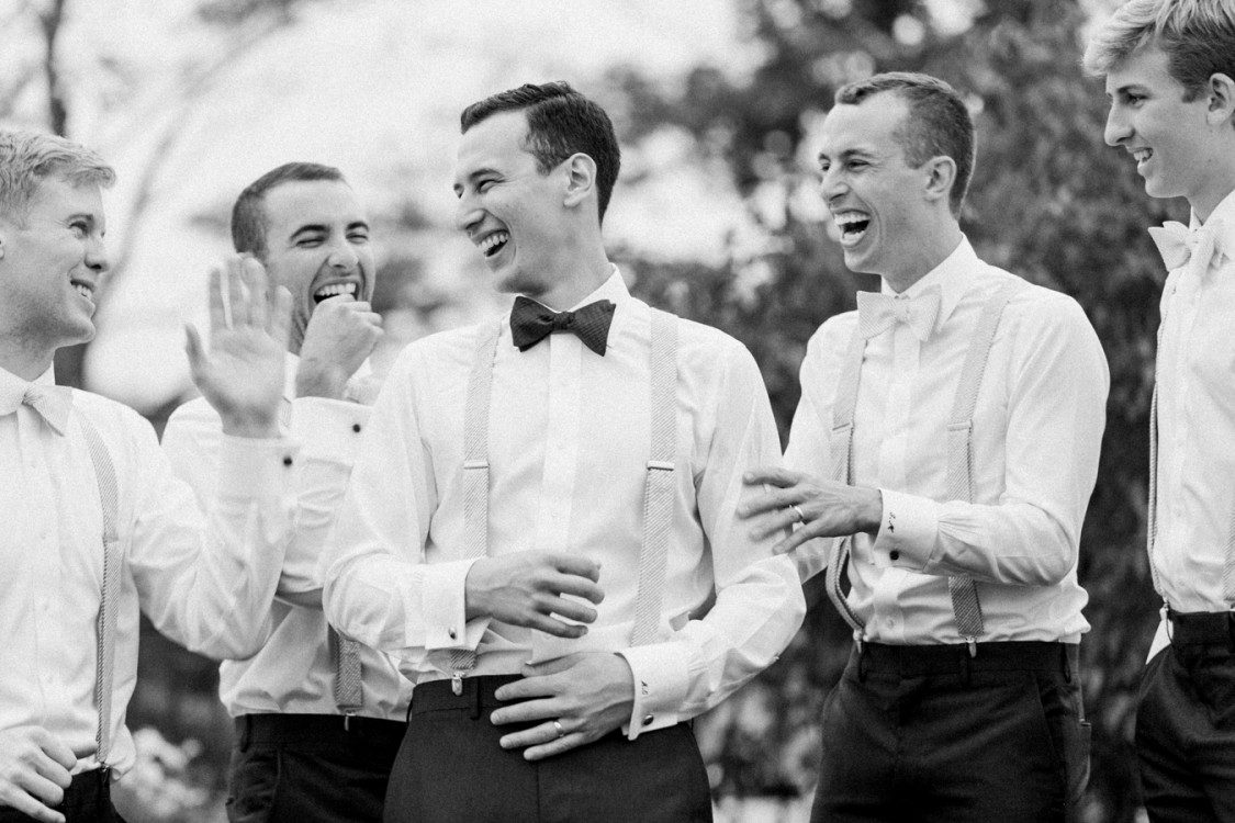 groom and groomsmen celebrate at a stylish northern michigan wedding