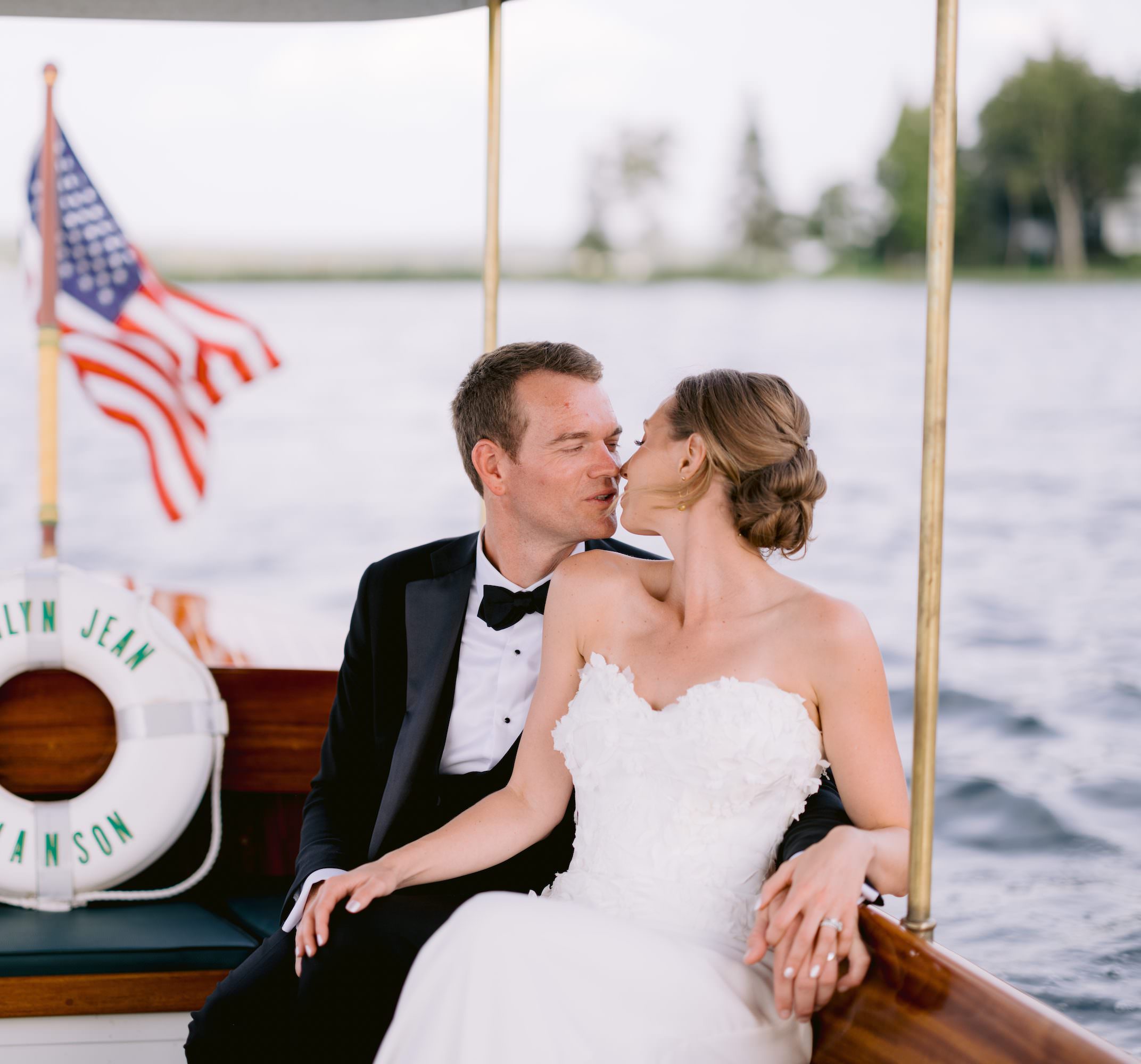 Newlyweds kiss on northern michigan wedding boat ride