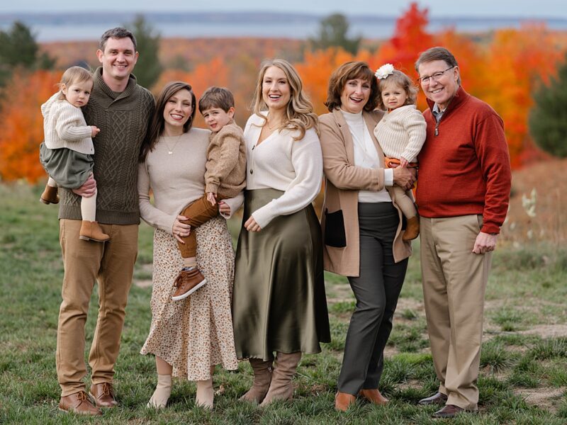 a family pose in unique family photo outfits in the fall